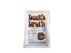 Beck’s Broth protein hot chocolate powder packet with cow mug illustration
