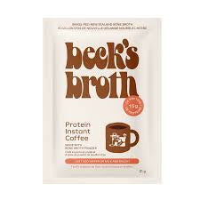 Beck’s Broth Protein Instant Coffee packaging with coffee cup and protein scoop on wooden table